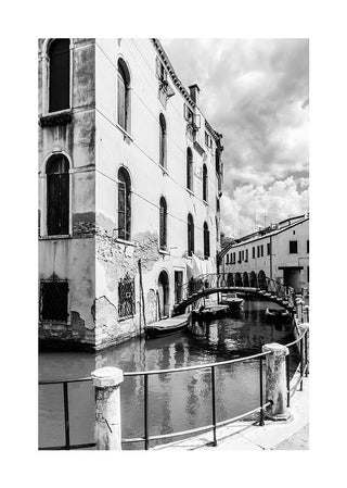 Black and white poster of a canal, bridge, and historic buildings in a European city.