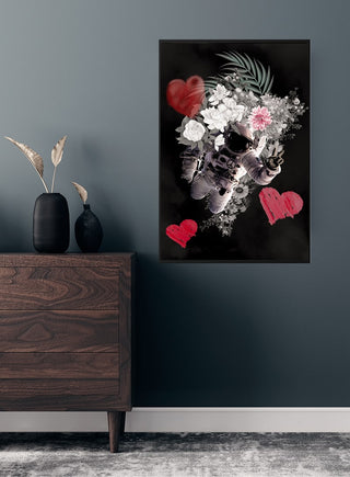 A poster featuring an astronaut surrounded by flowers and red hearts, displayed on a dark wall above a wooden dresser.