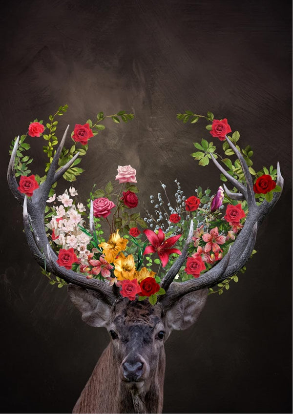A deer with antlers decorated with colorful flowers against a dark background.