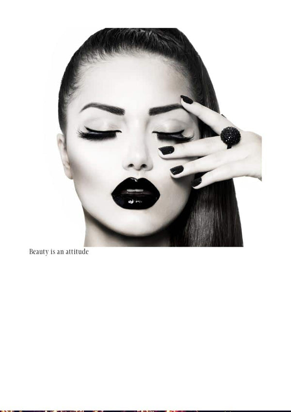 Black and white poster of a woman with bold makeup, dark lips, and the text "Beauty is an attitude."