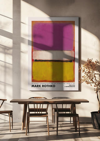 Framed Rothko Pink n Yellow abstract art print hangs above a modern dining table in a sunlit room.