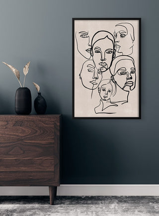 Poster titled "The Many Faces of a Woman" featuring abstract line drawings of women's faces on a wall.