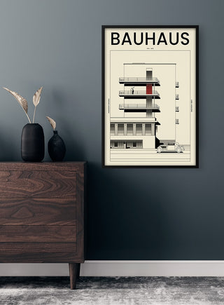 Framed Bauhaus Vintage Cover Plakat featuring minimalist architectural design on a dark wall above a wooden dresser.