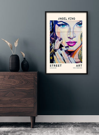 Framed Angel King no.2 street art print featuring a colorful, stylized portrait displayed on a dark wall.