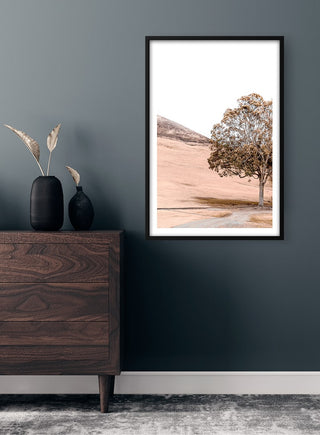 Framed Mountain Mirroring in Lake Plakat art print featuring a serene landscape hung above a wooden dresser.