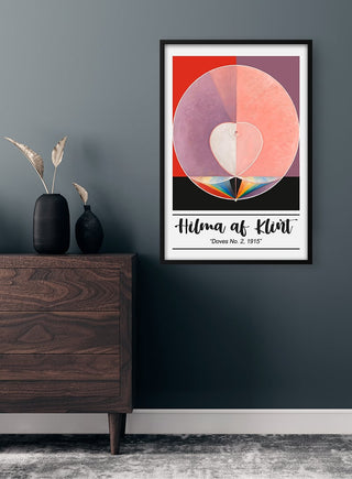 Hilma af Klint - Doves No. 2 Plakat art print hanging on a dark wall above a wooden dresser with vases.