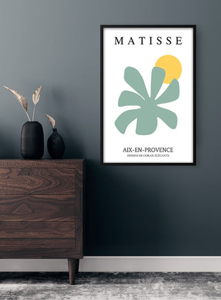 Framed Matisse Inspired Green Flower Plakat on a dark wall above a wooden dresser with decorative vases.