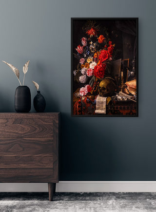 Framed Skull and Flowers Vintage Plakat poster displayed above a dark wood dresser in a modern room.