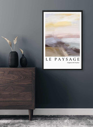Framed "Le Paysage - Avignon in the Vaucluse" art print on a grey wall above a modern wooden dresser.
