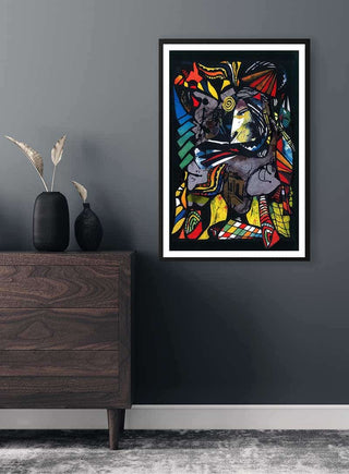Framed Colored Collage Plakat artwork on a dark wall above a wooden dresser with vases and dried plants.