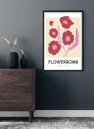 Red Flowerbomb Paris Plakat featuring abstract red flowers, framed and hung on a dark wall above a modern dresser.