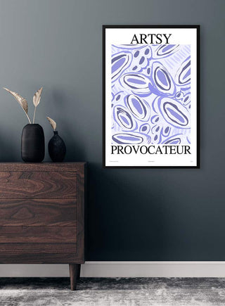 Framed Artsy Provocateur no. 02 Plakat with abstract blue shapes hanging on a dark wall above a wooden dresser.