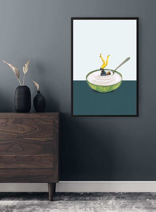 Framed print of "Yoga in my yogurt" by Maarten Léon hanging above a modern dresser in a stylish room.