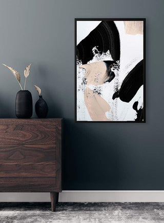 Black and Nude No 2 by Anastasia Sawall framed on a dark wall above a wooden dresser with minimalist decor.