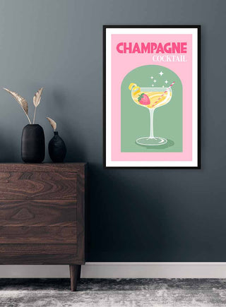 Framed Champagne Cocktail poster featuring a colorful drink illustration, displayed on a dark wall above a wooden dresser.