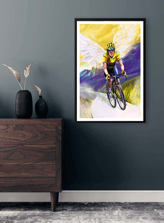 Poster of Jonas Vingegaard cycling, displayed on a dark wall above a wooden dresser.