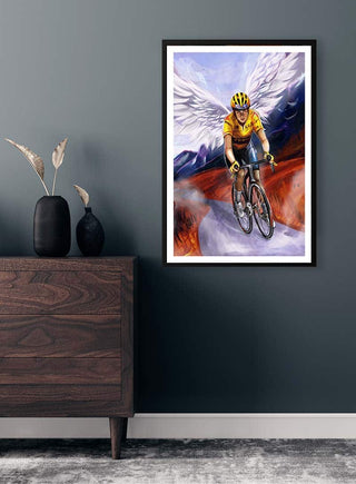 Poster of Jonas Vingegaard cycling with angel wings, by Danii Steinfeldt, displayed on a dark wall above a dresser.