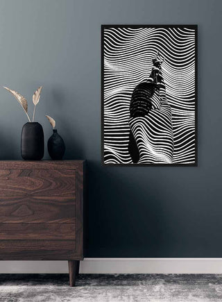 Black and white fashion wall art with wavy lines and a stylish figure, displayed in a modern room setting.
