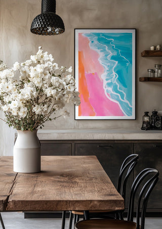 Pink hour on the beach by Ohkimiko in a black frame above a rustic table with white flowers