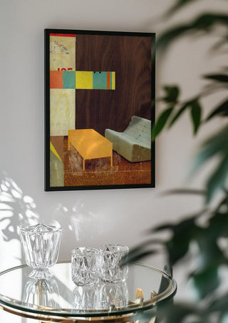 White Sofa by Kareem Rizk in a black frame above a glass table with crystal glassware