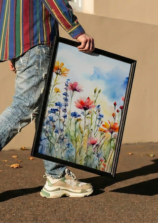 Wildflowers by Ohkimiko carried in a black frame along a sunny street