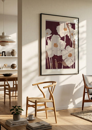 Abstract Flowers 10 by ThingDesign in a black frame in a bright dining room with wooden chairs