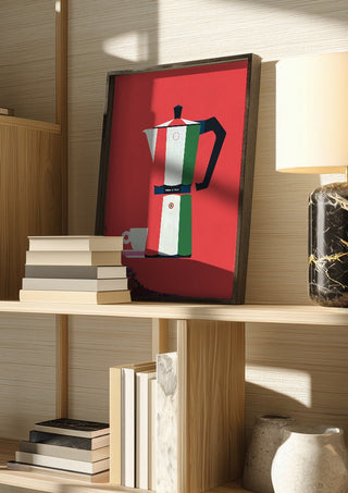 Italian coffee by Bo Lundberg in a dark frame on a wooden shelf beside books and a lamp