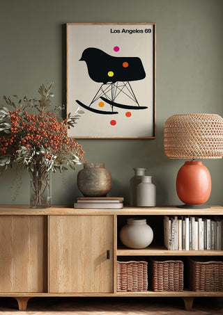 Los Angeles 69 by Bo Lundberg above a wooden sideboard on a sage green wall