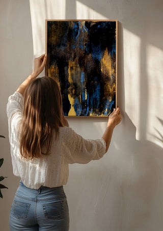 Gold on Blue by Kristof ellertz being hung on a sunlit wall