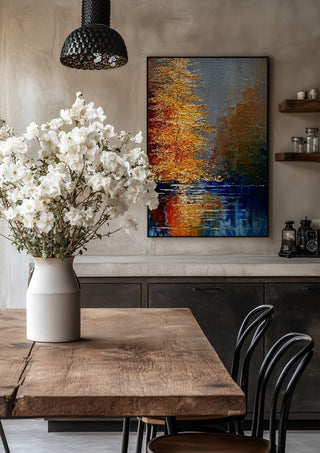 Autumn on the Water by Justyna Kopania in a black frame above a rustic table with white flowers