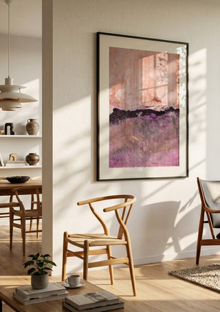 expressive landscape by Iris Lehnhardt in a black frame in a bright dining room with wooden chairs
