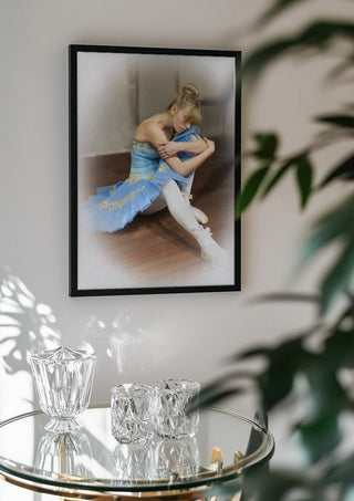 The Russian ballet dancer by Bettinafloorphoto in a black frame above a glass table with crystal glassware