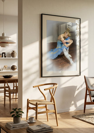 The Russian ballet dancer by Bettinafloorphoto in a black frame in a bright dining room with wooden chairs