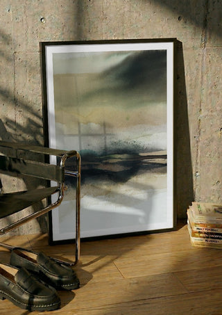Apparent infinity by Tania Zubareva in a black frame leaning against a concrete wall by a steel chair