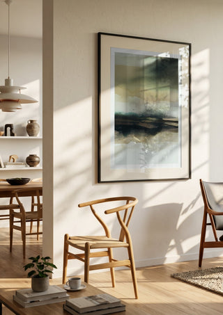 Apparent infinity by Tania Zubareva in a black frame in a bright dining room with wooden chairs
