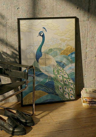 Peacock Touched by Gold by ArtySjak in a black frame leaning against a concrete wall by a steel chair