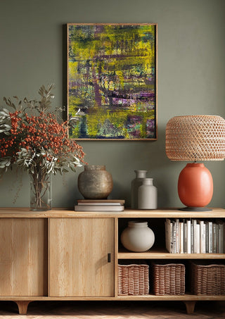Sonnenschein by Sophie Schillen above a wooden sideboard on a sage green wall