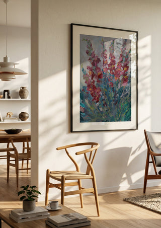 Red Snapdragon Flowers by DNF in a black frame in a bright dining room with wooden chairs