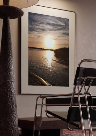 Light Finding the Shore by Bora Kőhalmi framed in a dim room beside a tubular steel chair