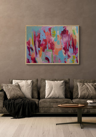 Warmth by Janet Bell in a light oak frame on a warm grey wall above a brown sofa