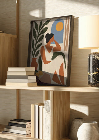 Contemplative Afternoon by TimlessArtworks in a dark frame on a wooden shelf beside books and a lamp