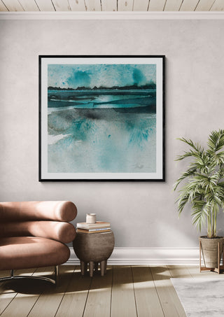 Reflections by Tania Zubareva in a black frame above a rose-pink armchair beside a palm