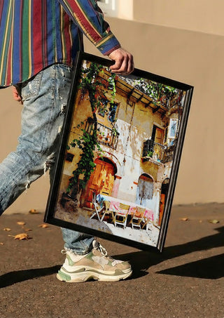 Italian courtyard by Massimo Frascogna carried in a black frame along a sunny street
