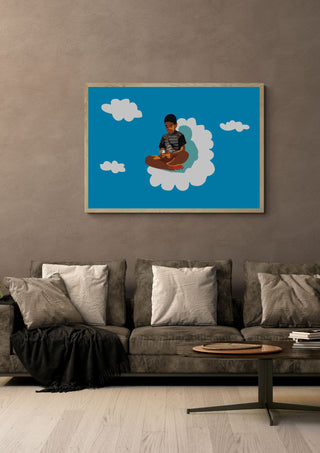 The kid on the cloud by Massimo Frascogna in a light oak frame on a warm grey wall above a brown sofa