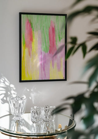Pinky flow by FridaRit in a black frame above a glass table with crystal glassware