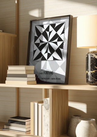 Classic Fortune - Pleasure Signal by Amadeus Fuchs in a dark frame on a wooden shelf beside books and a lamp