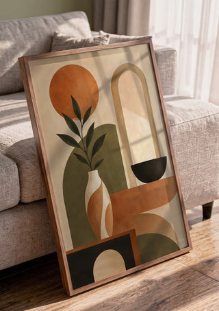 Abstract Earth-Tone Still Life by TimlessArtworks in a walnut frame leaning against a grey sofa