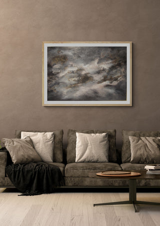 Skuggornas dans by Ljilja Marinic in a light oak frame on a warm grey wall above a brown sofa