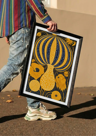 Yellow Dotted Pumpkin by Yokohama carried in a black frame along a sunny street