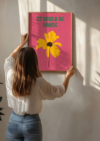 It Could Be Worse by Jakob Falkenberg being hung on a sunlit wall